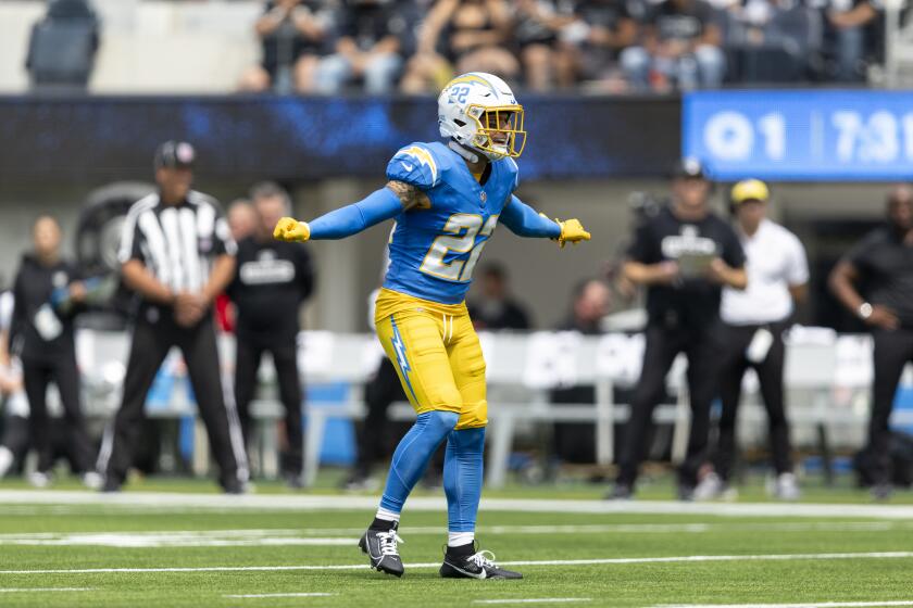 Chargers safety Elijah Molden signals teammates from the defensive backfield.