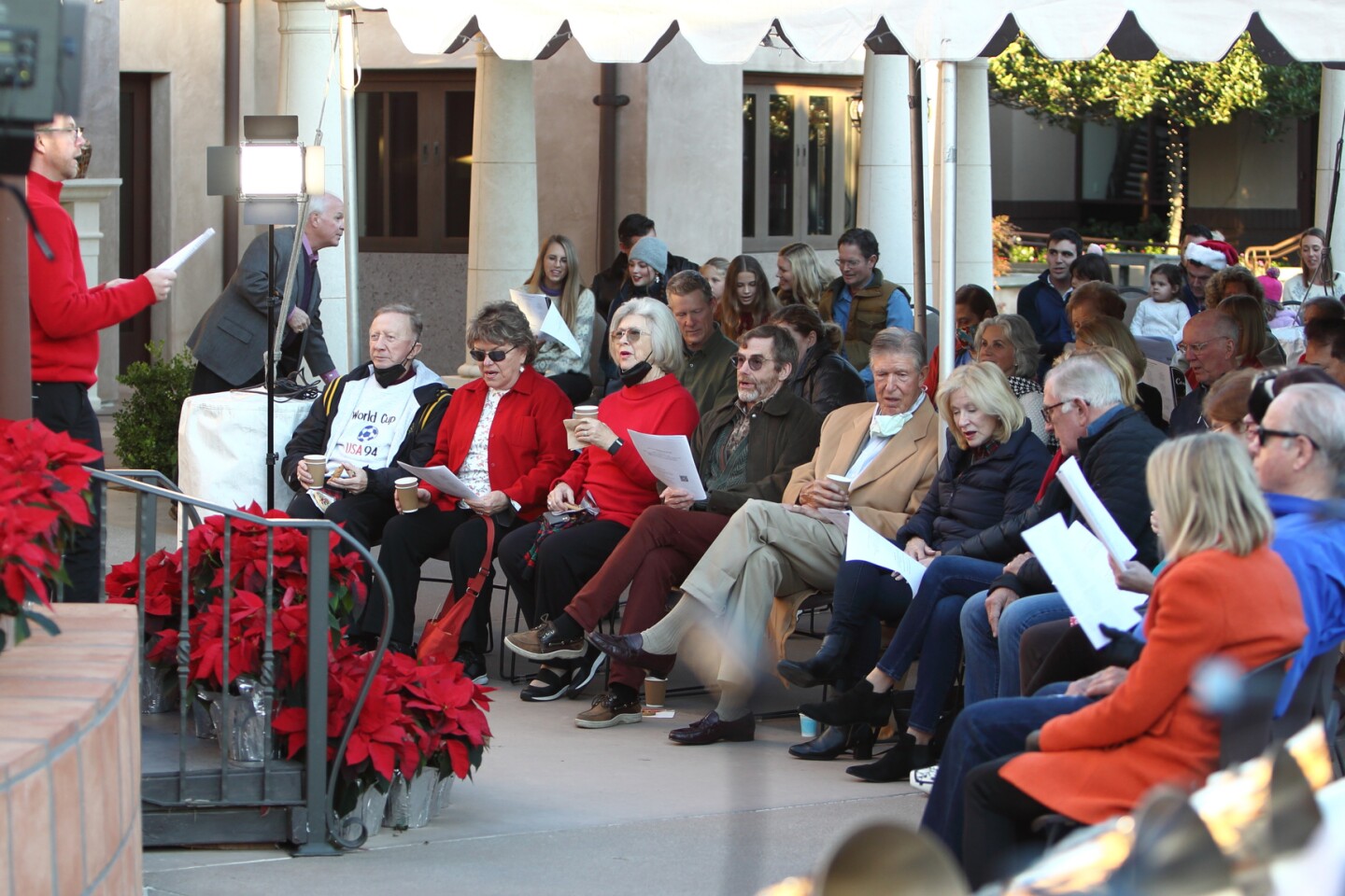 Attendees join in singing Christmas carols at The Village Church "Coming Home at Christmas" event