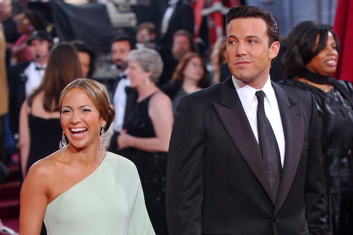 Jennifer Lopez in a one-shouldered gown and Ben Affleck in a dark suit