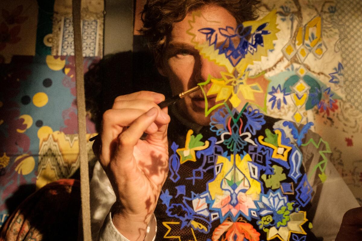 Benedict Cumberbatch seen through a painting holding a paintbrush