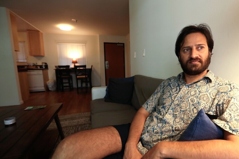 Mukesh Kulriya, a UCLA Ph.D. student in the Ethnomusicology program, sits in the living room of his apartment in Culver City