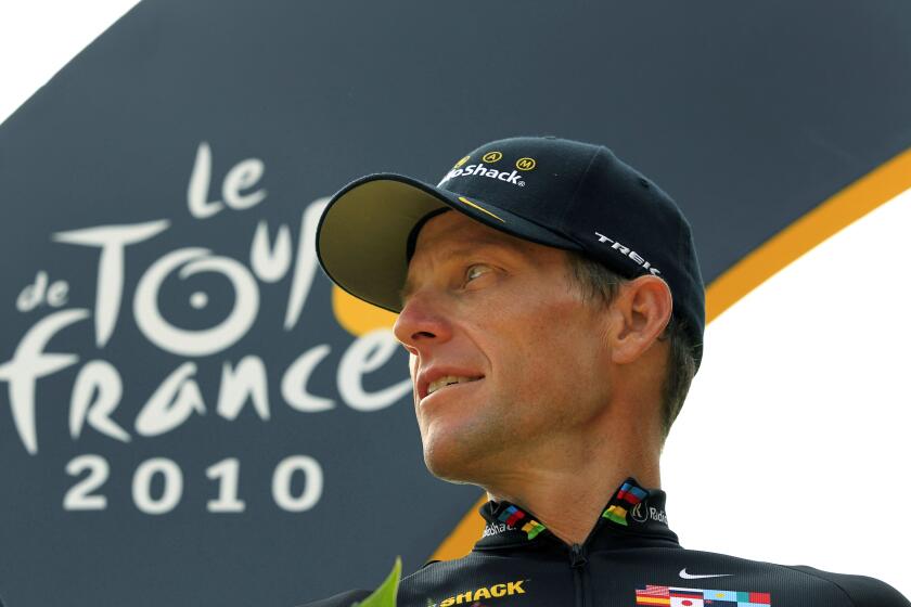 FILE - This file photo taken July 25, 2010, shows Lance Armstrong looking back on the podium after the 20th and last stage of the Tour de France cycling race in Paris, France. Cycling leaders let doping flourish and broke their own rules so Lance Armstrong could cheat his way to become a superstar the sport badly needed, according to a scathing report into its drug culture published Monday, March 9, 2015. The International Cycling Union was severely criticized for failing to act during the doping era dominated by Armstrong, but the 227-page report found no evidence that he paid to cover up alleged positive tests. (AP Photo/Bas Czerwinski, File)
