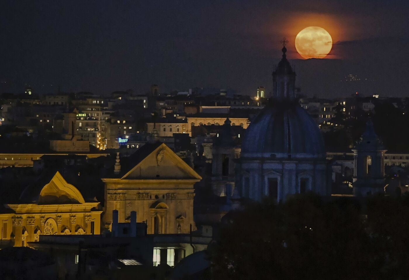 A full moon illuminates Rome's skyline.