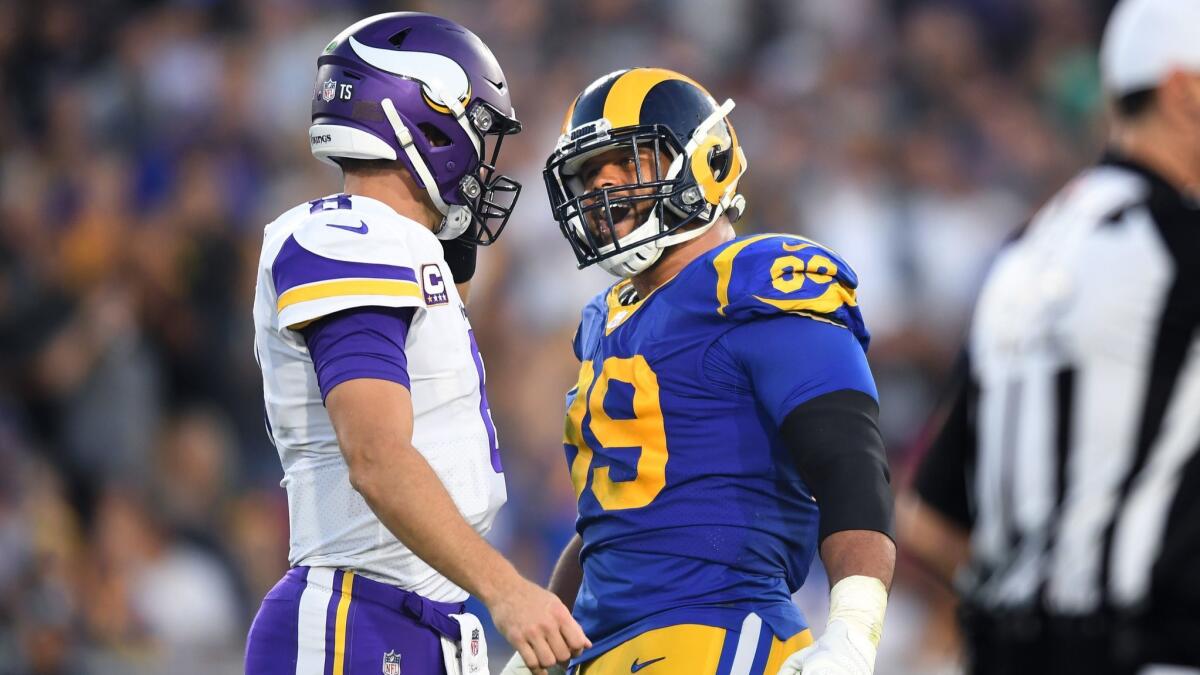 Rams defensive tackle Aaron Donald has a few words with Vikings quarterback Kirk Cousins at the Coliseum.