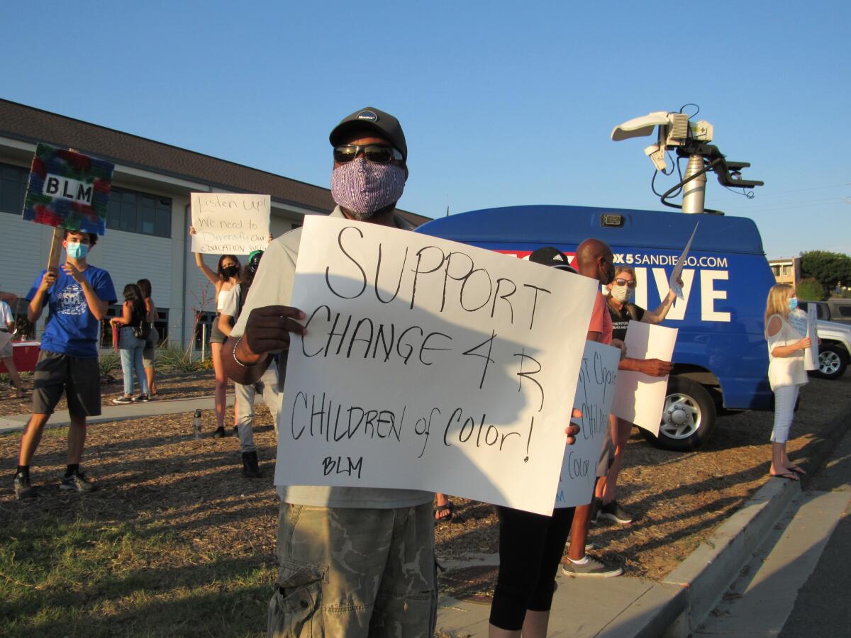 A parent protests in Encinitas on Aug. 14.