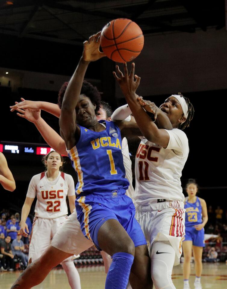 UCLA guard Kayla Owens (1) and USC guard Aliyah Jeune (11) battle for a rebound during the first half of a game Jan. 17 at Galen Center.