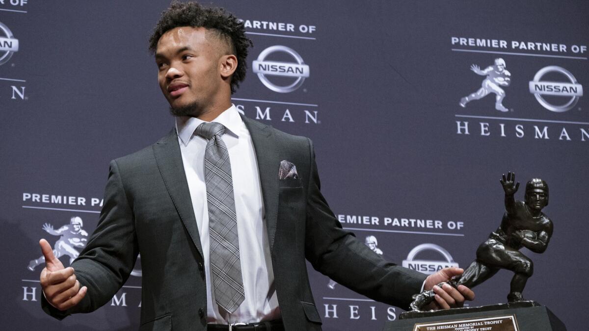 Oklahoma quarterback Kyler Murray holds the Hesiman Trophy on Dec. 8.