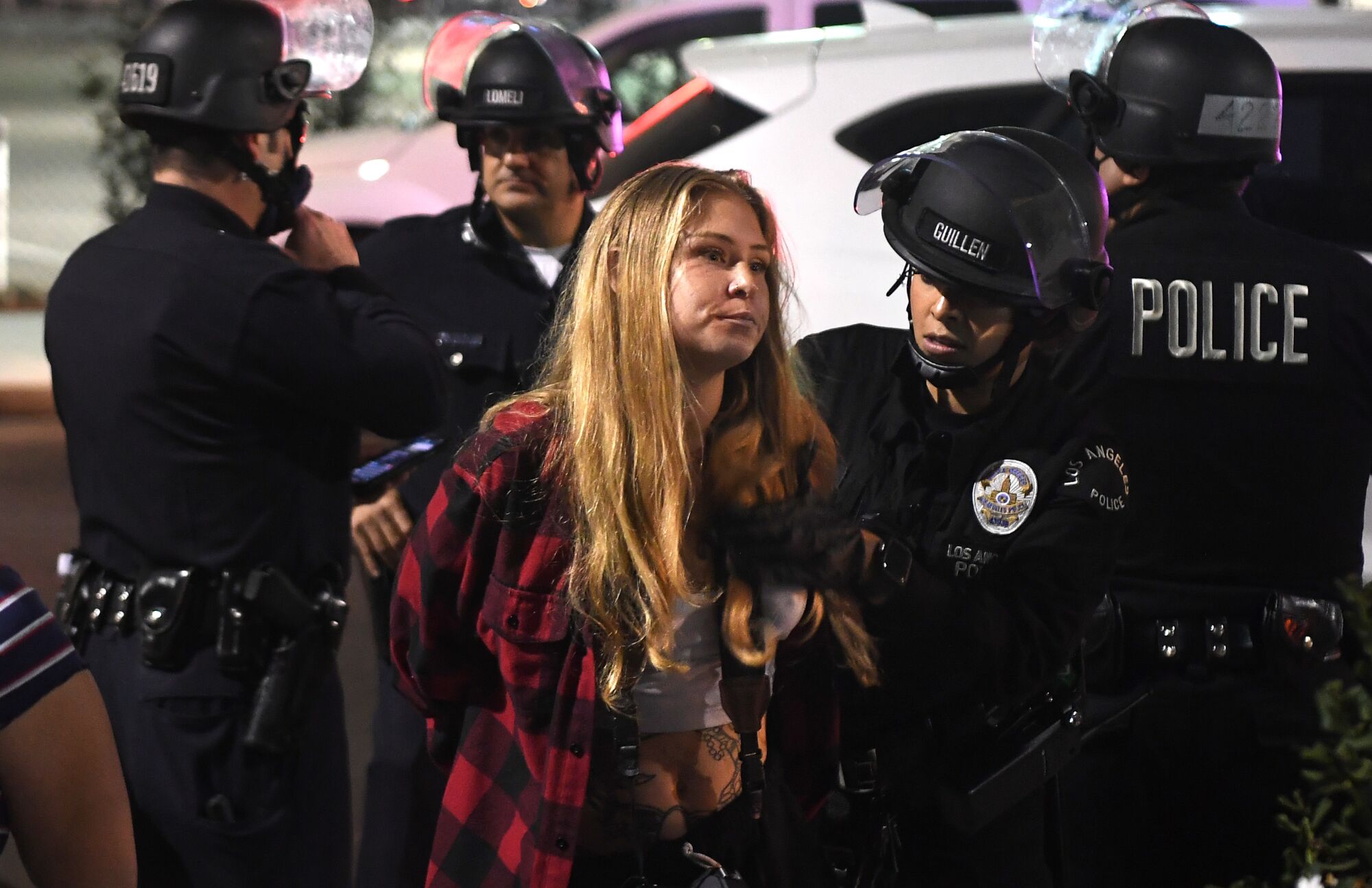 Police detain protesters near 18th and Figueroa streets in downtown Los Angeles on Tuesday night.