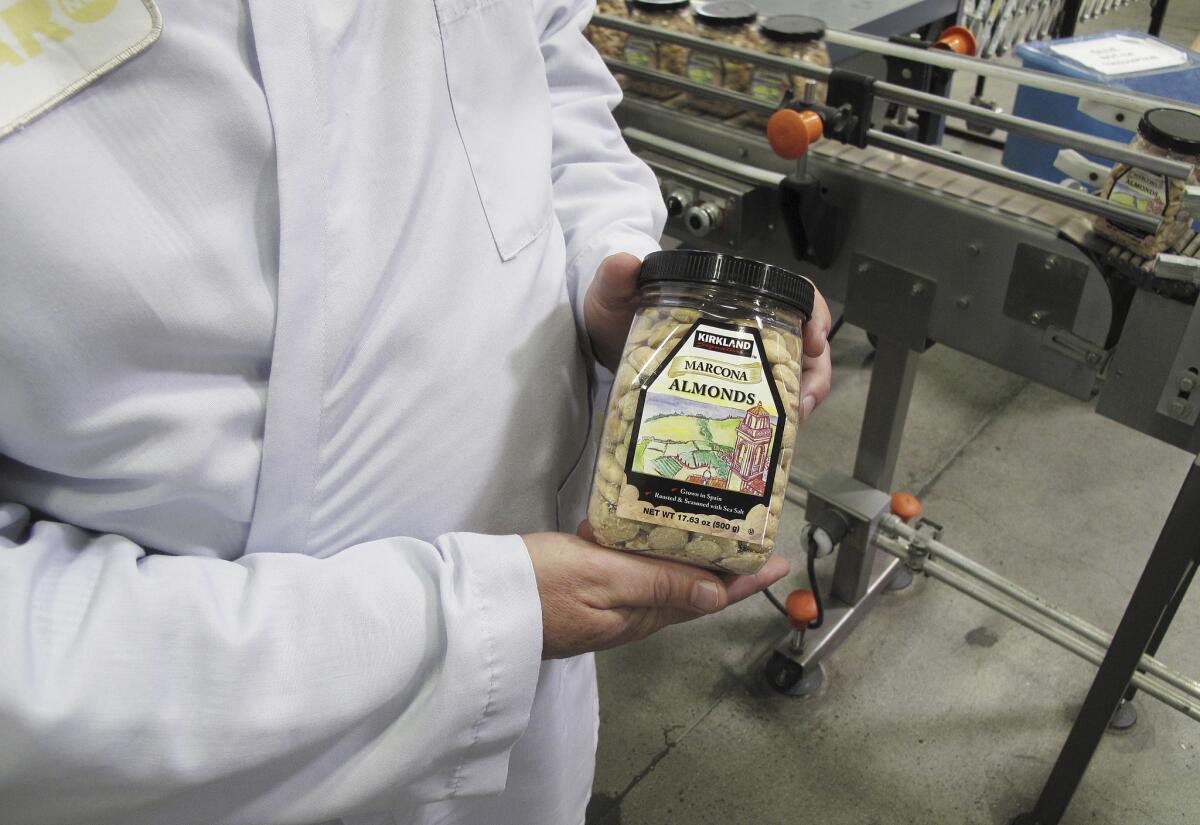 Todd Crosswell, general manager of Caro Nut Co., holds a packaged jar of almonds at the company's nut processing plant in Fresno. Sophisticated thieves last year stole six truckloads from Caro Nut last year at a loss of $1.2 million to the firm.