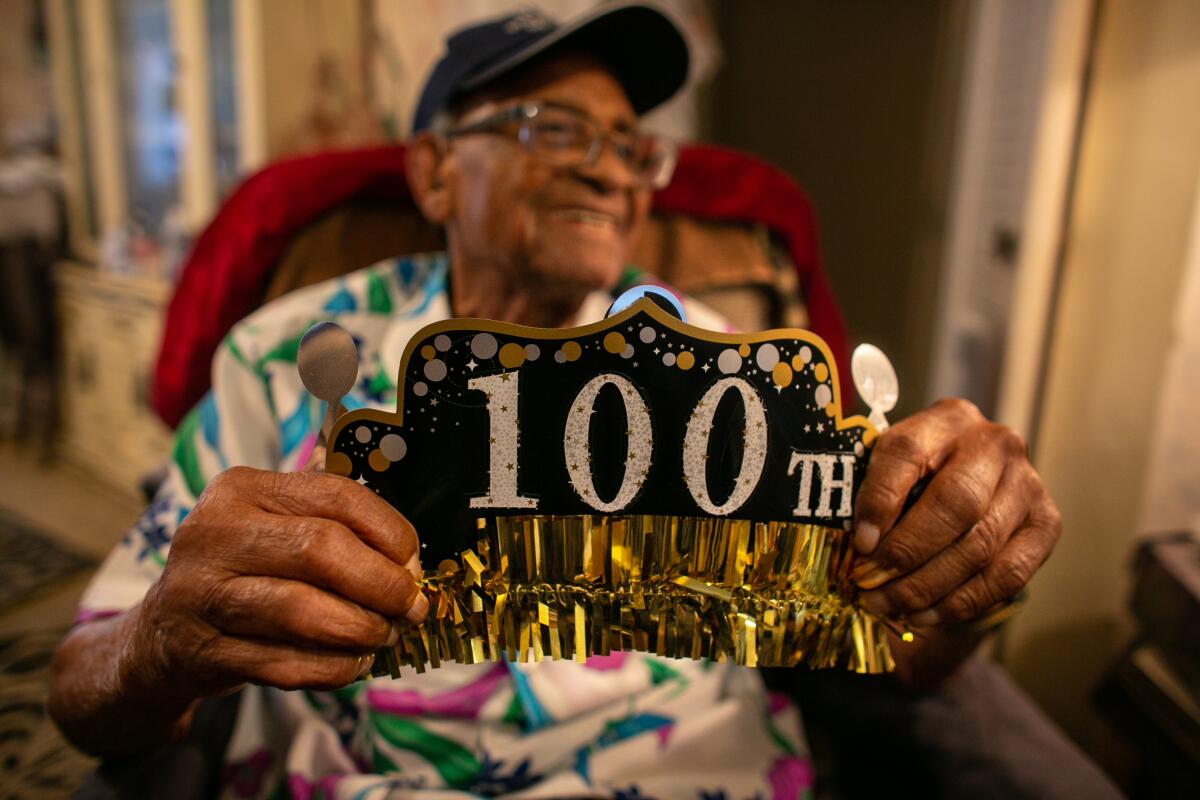 Robert Hayes holds his birthday crown after celebrating his 100th birthday in Los Angeles in 2021. 