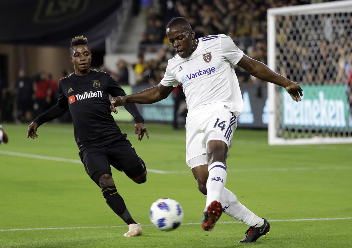 Real Salt Lake's Nedum Onuoha, right, clears the ball as LAFC's Latif Blessing closes in during a playoff match in 2018.