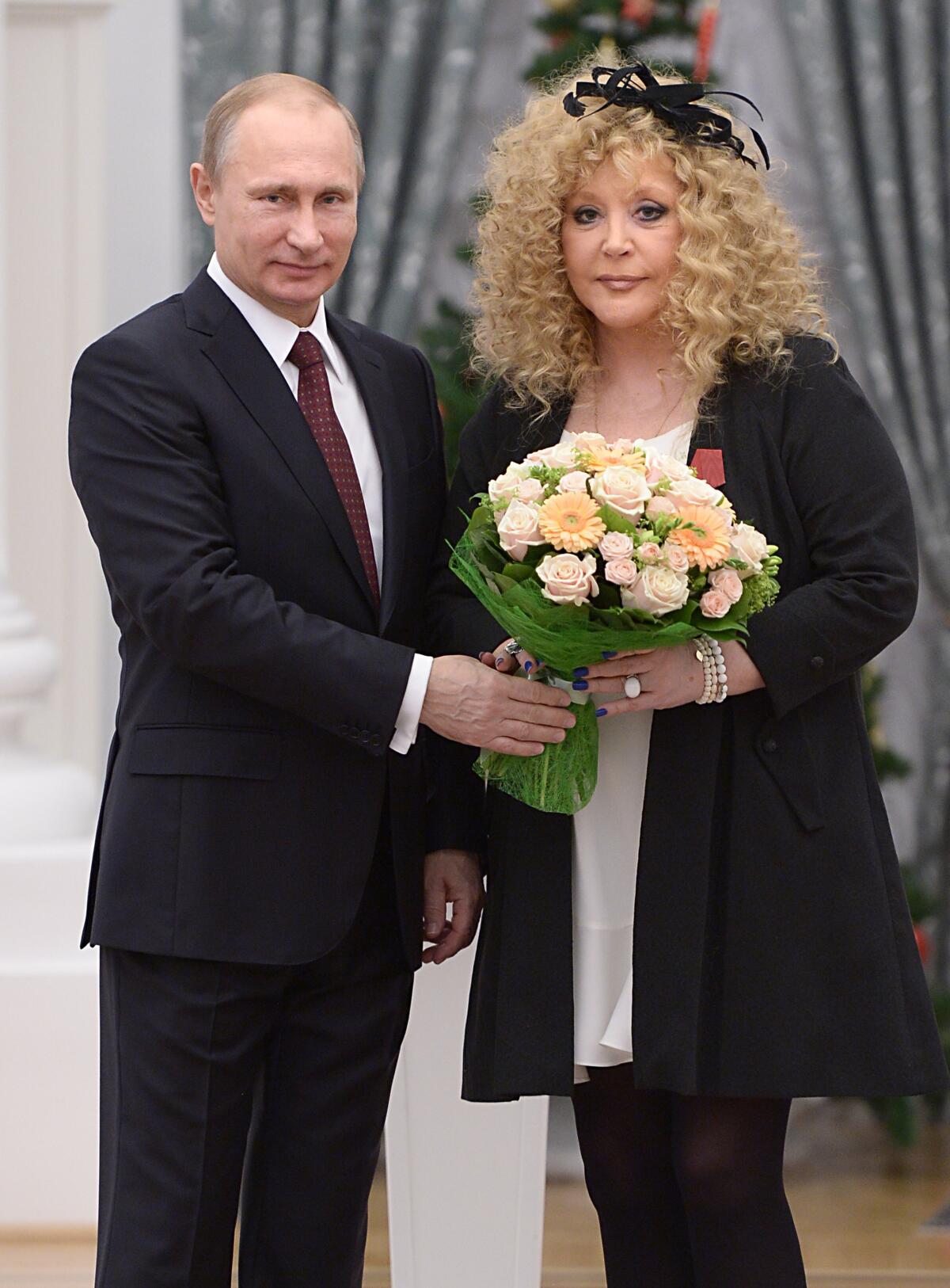 Russian President Vladimir Putin and pop singer Alla Pugacheva