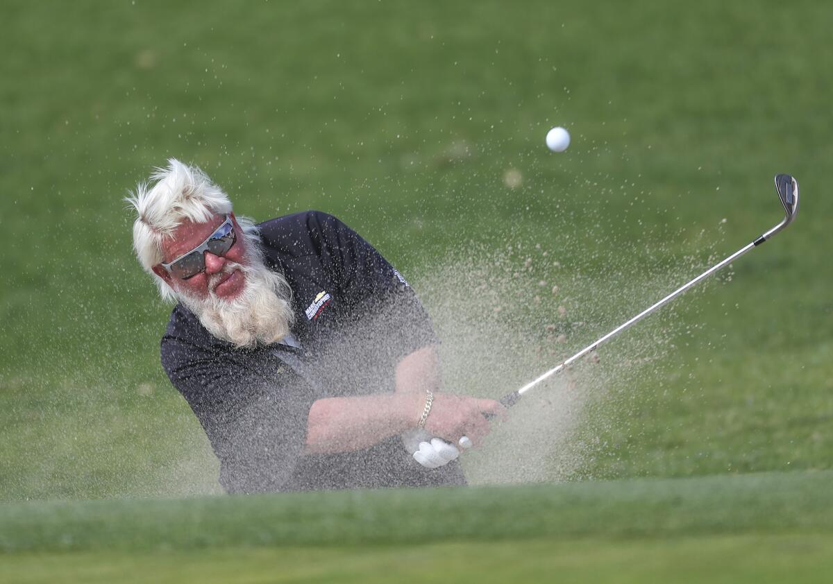 Crowd favorite John Daly hits out of a green-side bunker on day one of the Hoag Classic on Friday.