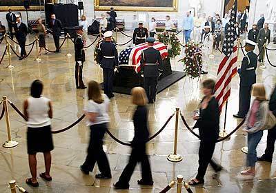Visitors view former President Reagan 's casket inside the U.S. Capitol Rotunda today in Washington, DC. Reagan 's national funeral service will be held at the National Cathedral.