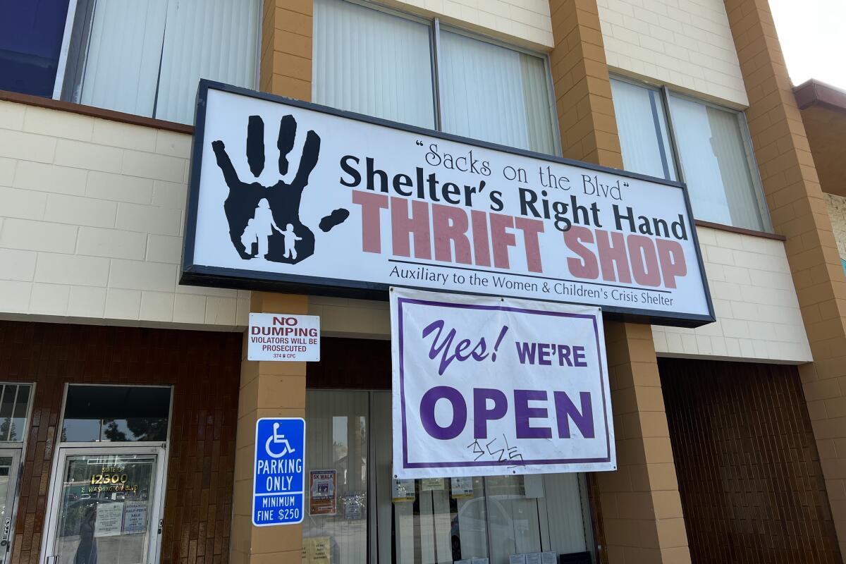 A "Yes we're open!" sign on the front of Shelter's Right Hand Thrift Shop