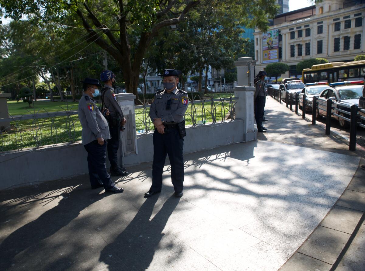 Police on a sidewalk in Yangon