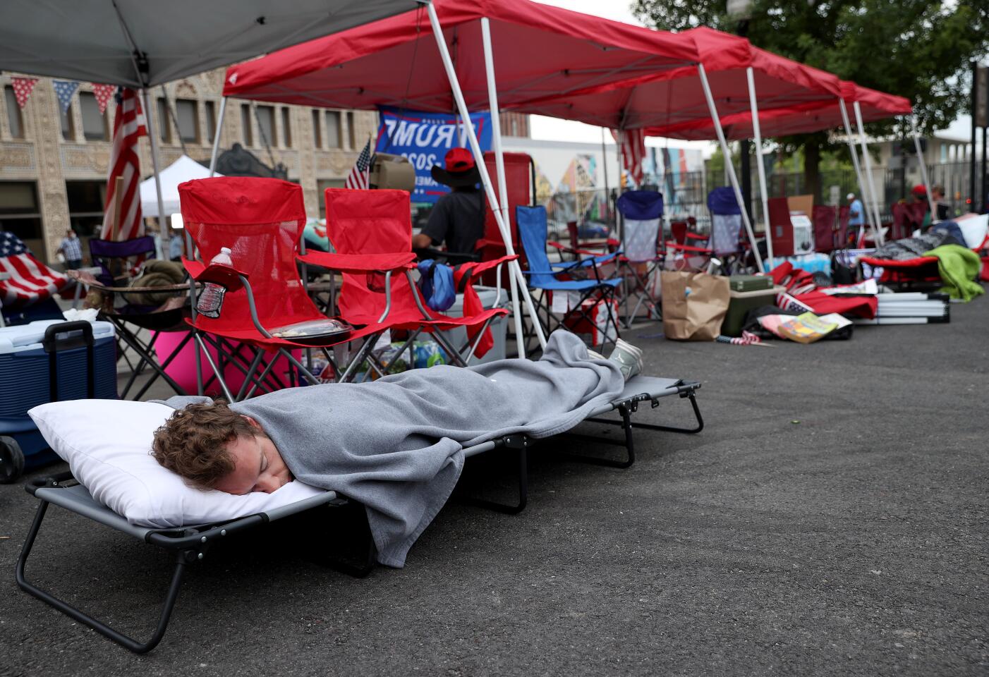 Supporters of President Trump sleep in line to attend his campaign rally at the BOK Center in Tulsa.