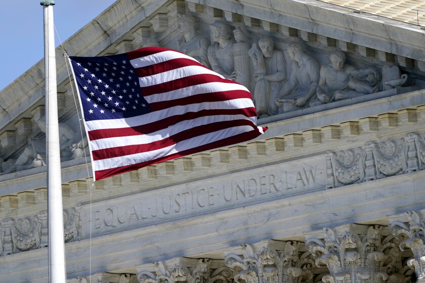 The U.S. flag waves in front of the Supreme Court building in Washington, D.C. 