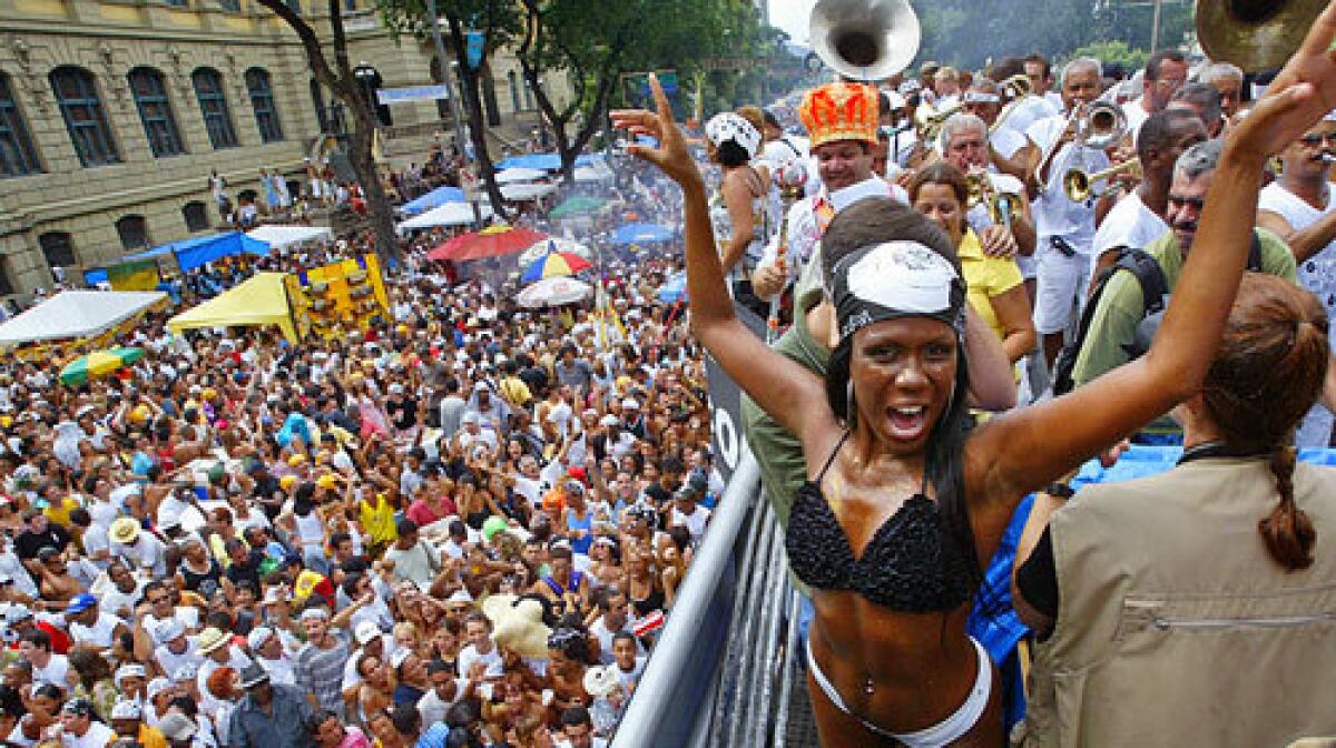 PARADE ROUTE: A dancer and musicians performed for a crowd in Rio de Janeiro during Carnaval in 2005.