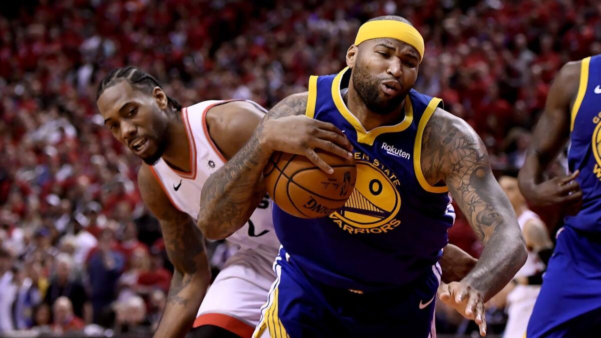 Golden State Warriors center DeMarcus Cousins drives past Toronto Raptors forward Kawhi Leonard during Game 2 of the NBA Finals on June 2. Cousins played a vital role in the Warriors' win.