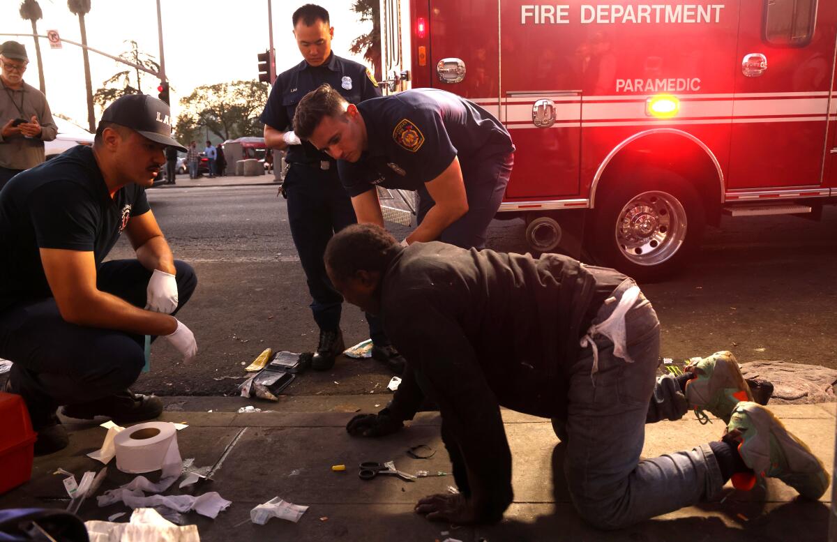 Paramedics treating a person who overdosed