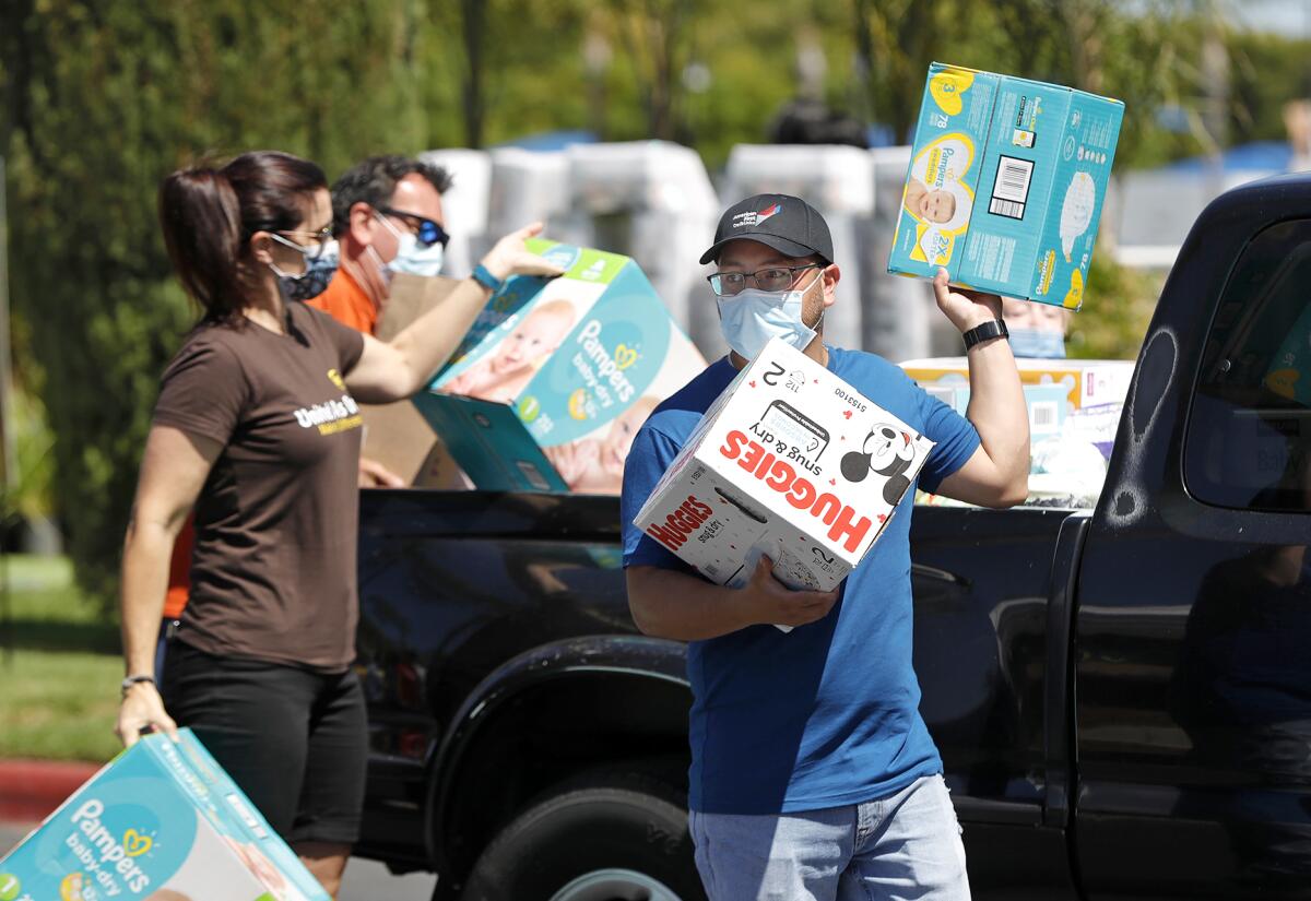 Volunteer groups unload boxes of diapers for the Home Aid Orange County diaper drive.