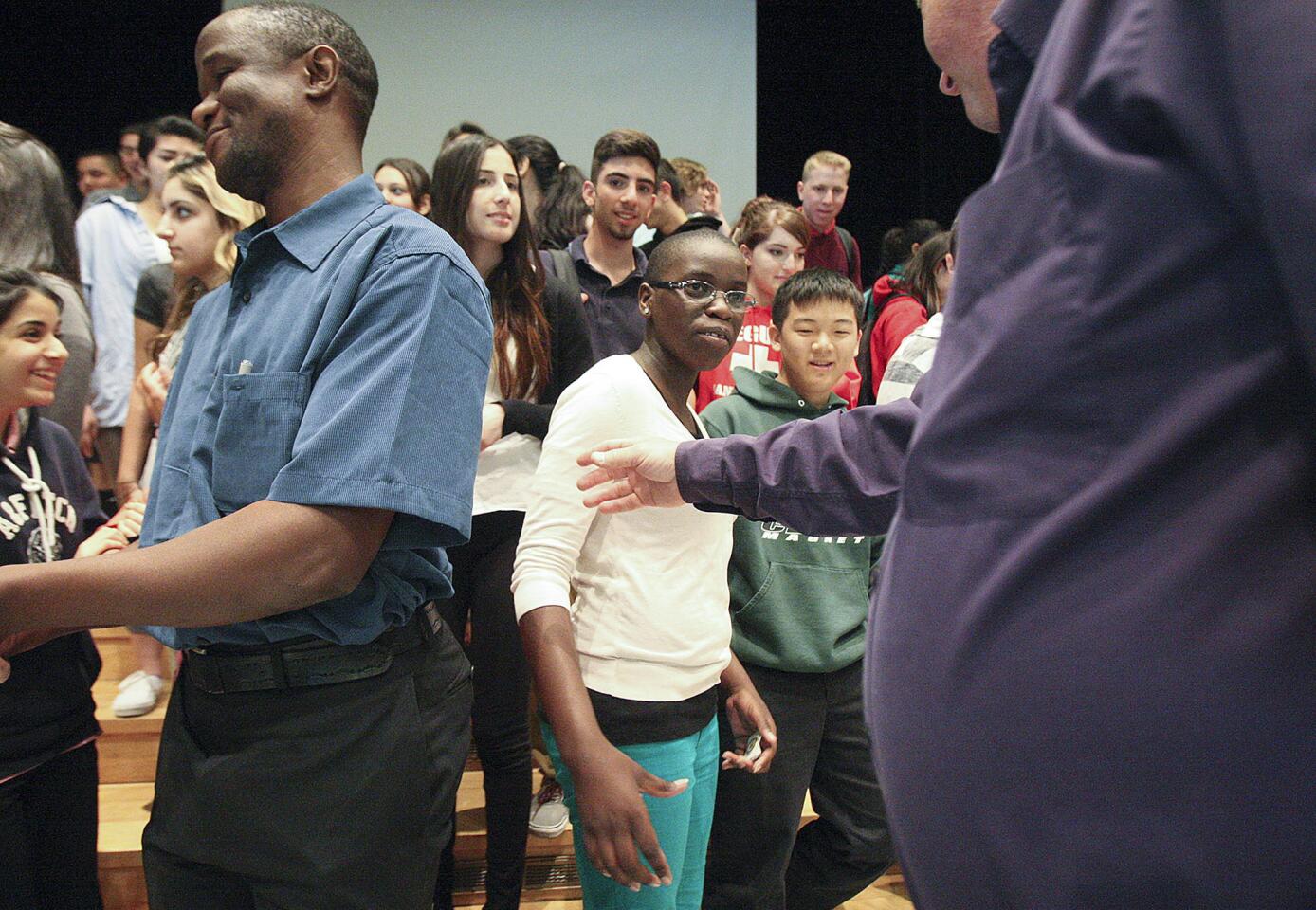 Phiona Mutesi, center, is the center of attention for students and adminstration to be photographed with at Clark Magnet High School in Glendale on Monday, April 28, 2014. Mutesi grew up in the slums of Uganda and through the game of chess has lifted herself out of the slums onto the international stage for chess and to raise awareness about the plight of her Ugandan people. After her presentation for the students of Clark Magnet, she played against local chess grandmaster Tatev Abrahamyan, of Glendale.