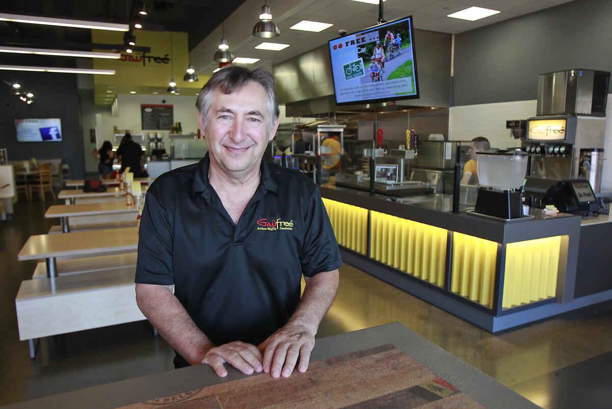 Owner and operator Paul Hortobagyi stands at the community table in his new Gaufree Artisanal Waffle Sandwiches eatery in Irvine.