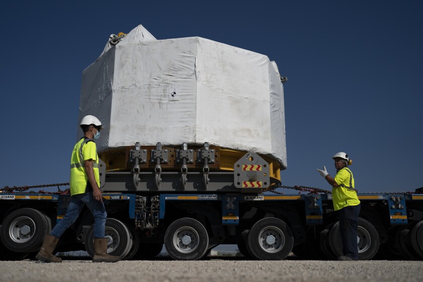 Workers receive a central solenoid magnet for the International Thermonuclear Experimental Reactor project.