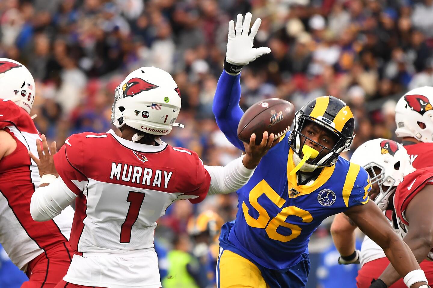 Rams linebacker Dante Fowler Jr. tries to knock the ball away from Arizona Cardinals quarterback Kyler Murray.