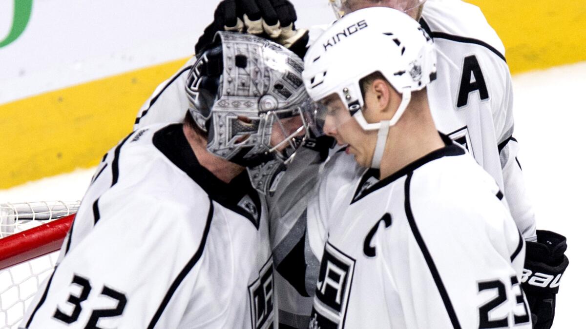 Kings captain Dustin Brown congratulates goalie Jonathan Quick after a 3-0 victory over the Canadiens on Thursday night in Montreal.