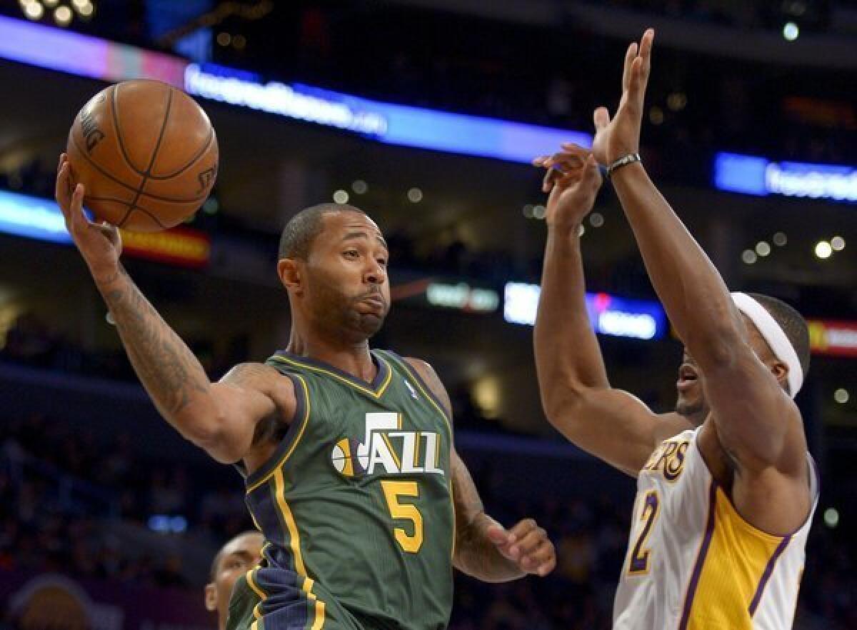 Utah Jazz guard Mo Williams passes around Lakers center Dwight Howard