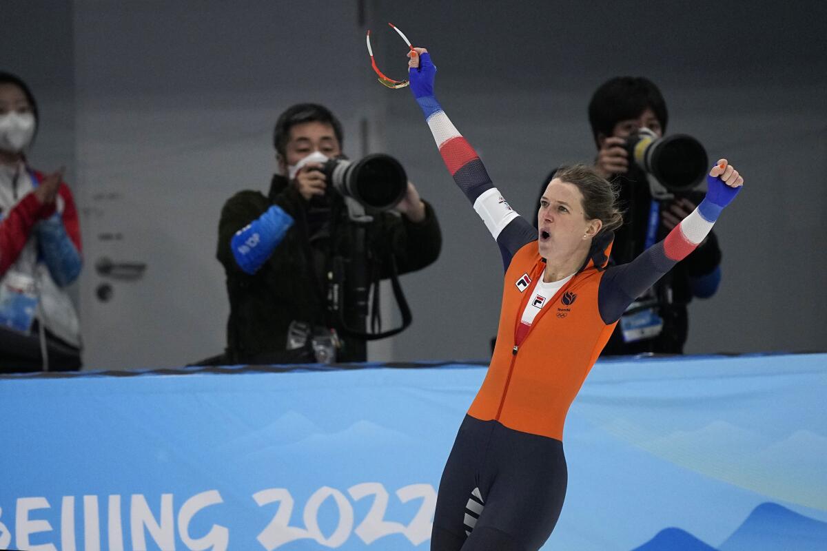 Ireen Wust of the Netherlands reacts after breaking an Olympic record in the women's speedskating 1,500-meter race.