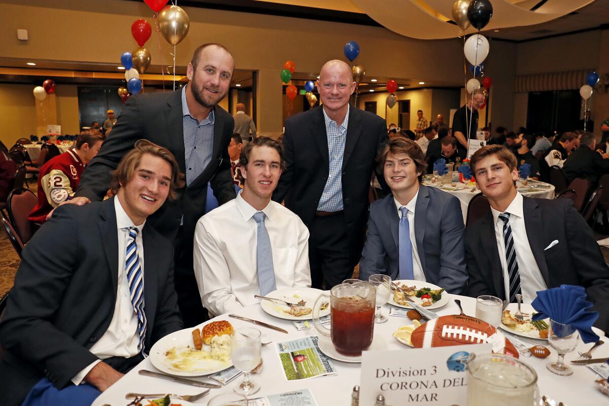 Corona del Mar tight end Mark Redman, left, offensive coordinator Kevin Hettig, receiver John Humphreys, coach Dan O'Shea, quarterback Ethan Garbers and linebacker Mason Gecowets attend the CIF Southern Section football championship luncheon on Monday at the Grand in Long Beach.