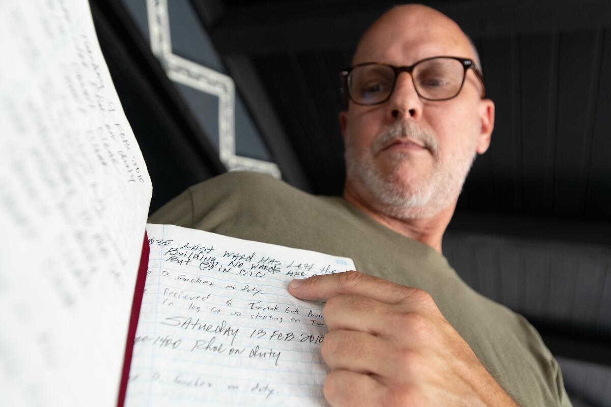 David Reeve holds a logbook from Youth Training School, a former youth prison in Chino.