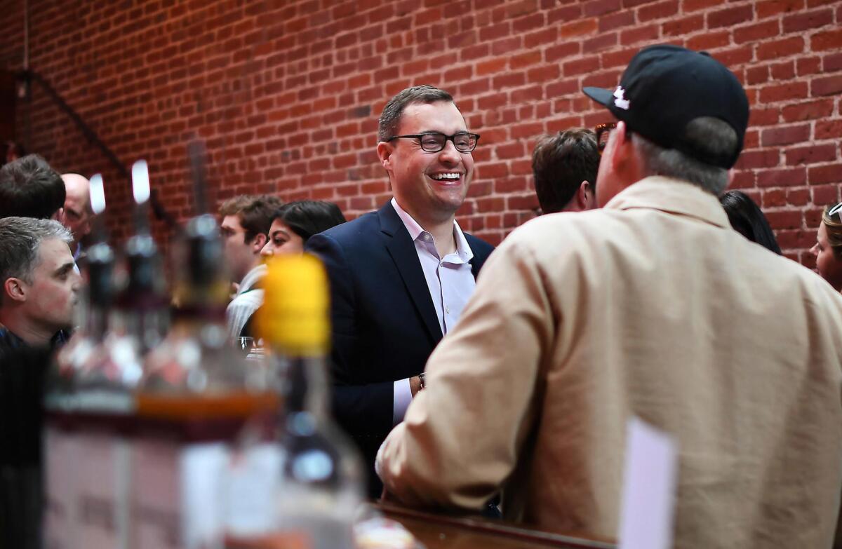 Ben LaBolt, of Bully Pulpit Interactive, center, socializes at an event at Natoma Cabana, a bar in San Francisco.