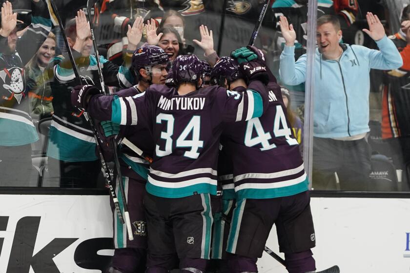 Anaheim Ducks surround center Sam Carrick after his goal during the third period.