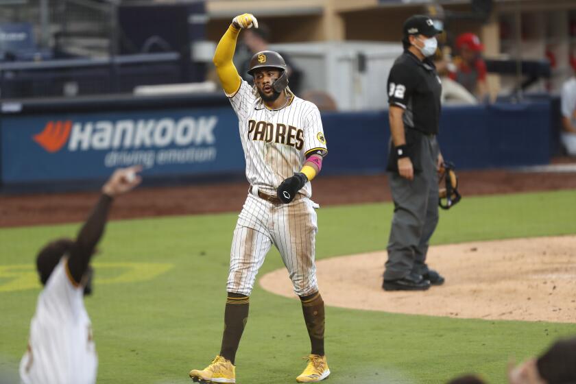 Fernando Tatis Jr. of the San Diego Padres scores on a double by Eric Hosmer.
