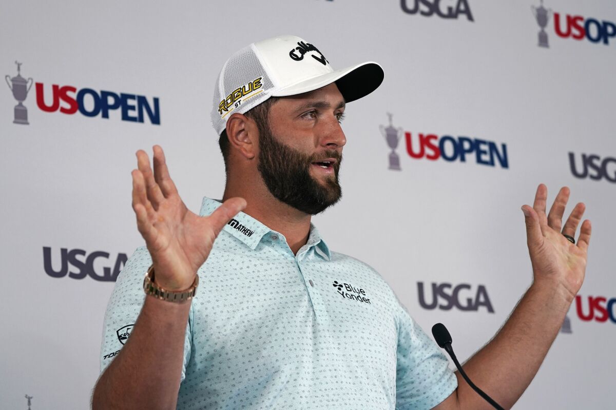Jon Rahm, of Spain, answers a reporter's question during a media availability ahead of the U.S. Open golf tournament, Tuesday, June 14, 2022, at The Country Club in Brookline, Mass. (AP Photo/Charles Krupa)