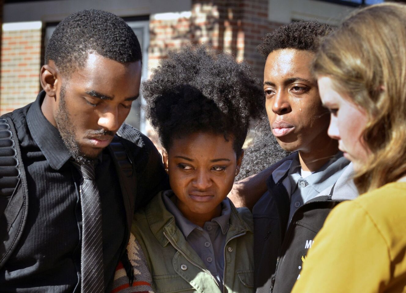 Members of the Legion of Black Collegians and the Concerned Student 1950 supporters gather outside the Reynolds Alumni Center after an emotional protest on the University of Missouri campus in Columbia, Mo.
