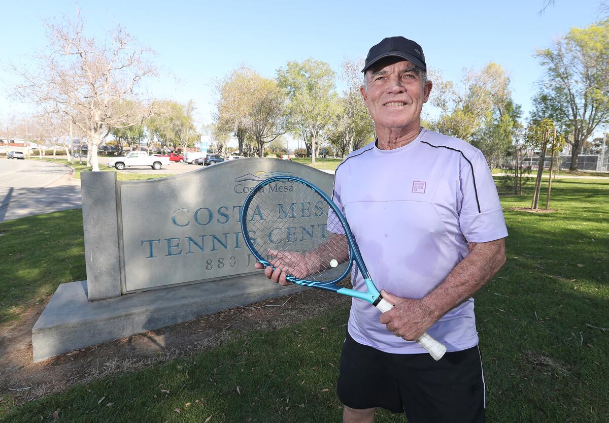 Hank Lloyd stands in front of the Costa Mesa Tennis Center marquee in Costa Mesa on Tuesday. 