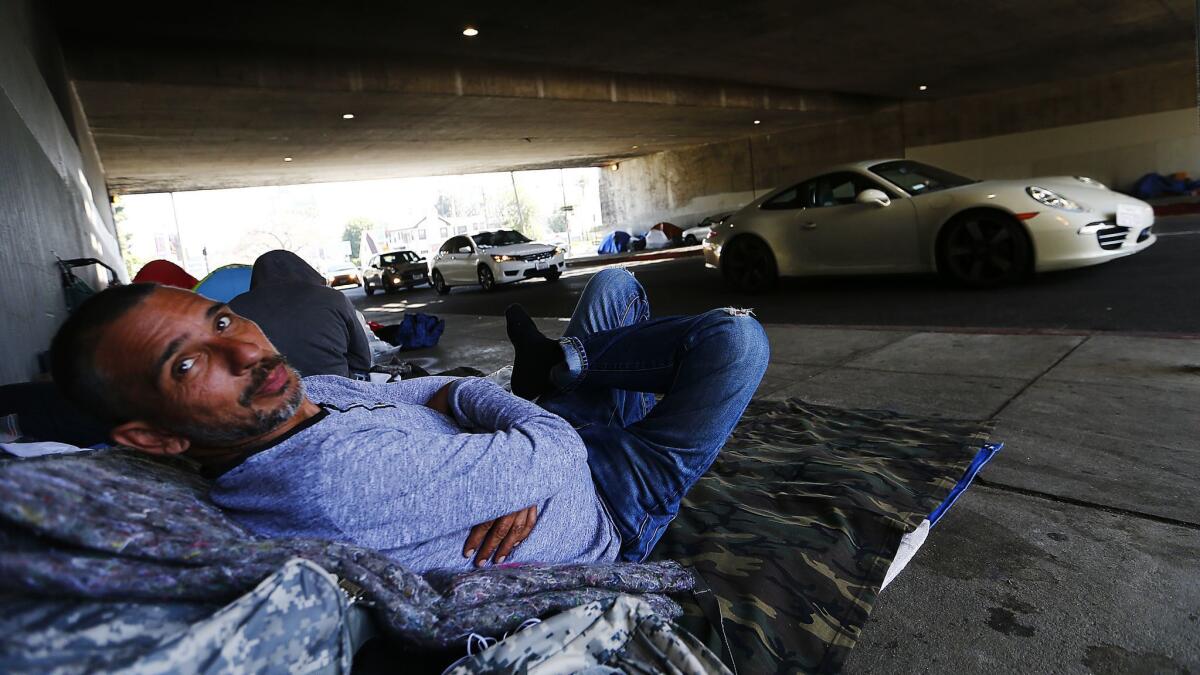 Travis, a veteran who served in Afghanistan, lives on Gower Street beneath the 101 Freeway in Hollywood.