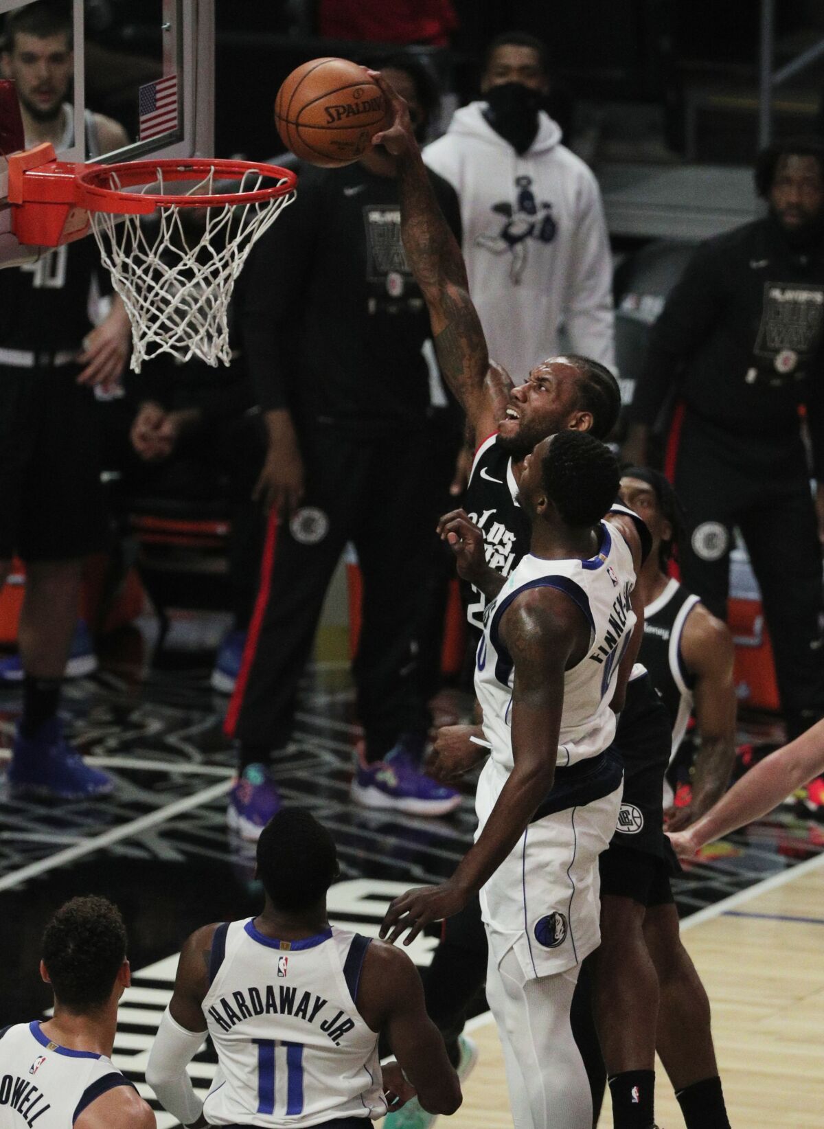 Clippers forward Kawhi Leonard dunks over Mavericks forward Dorian Finney-Smith.