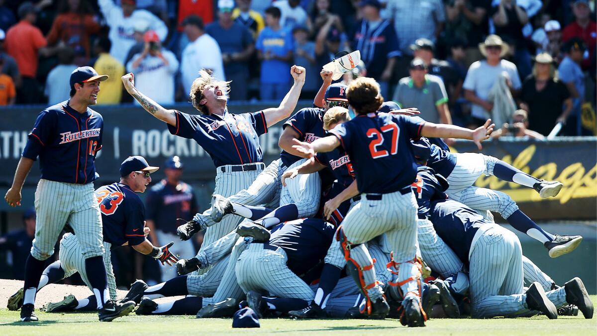 The Fullerton Titans baseball team celebrates after defeating Long Beach State in the final game of the College World Series Super Regional at Blair Field in Long Beach on Sunday, June 11, 2017.