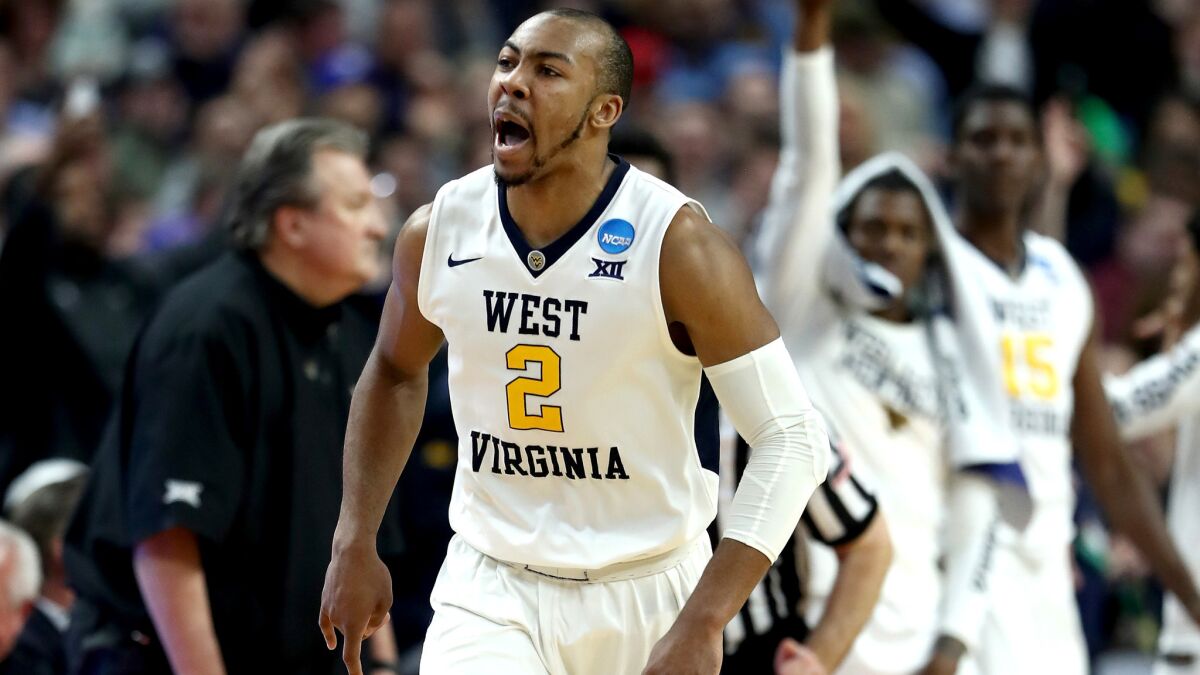 West Virginia guard Jevon Carter reacts after making a three-pointer against Notre Dame.
