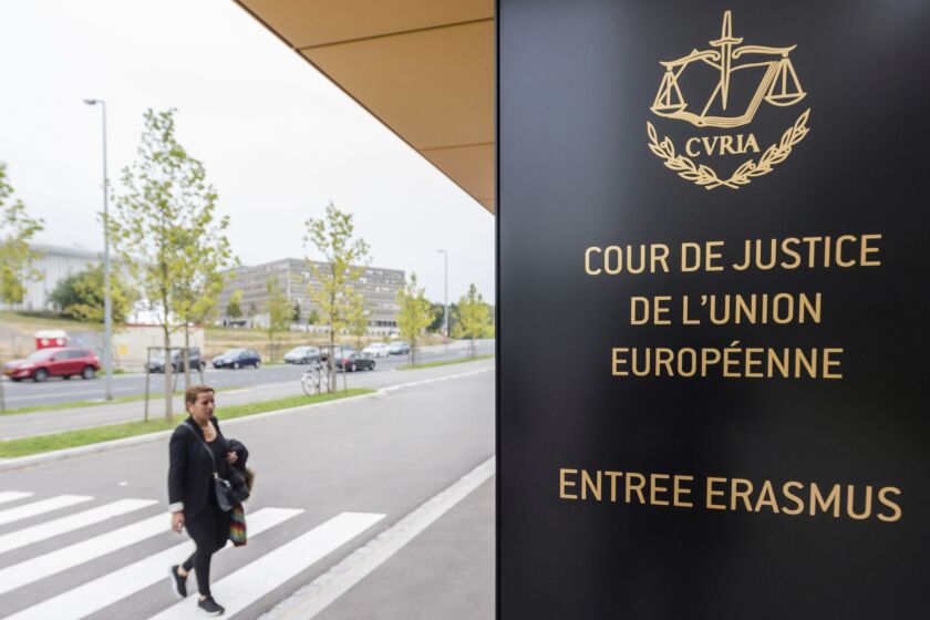 FILE - In this photo taken on Oct. 5, 2015 a woman walks by the entrance to the European Court of Justice in Luxembourg. The European Union’s top court says Google has to delete search results about people in Europe if they can prove that the information is clearly wrong. People in Europe have the right to ask search engines to delete links to outdated or embarrassing information about themselves, even if it is true, under a principle known as “right to be forgotten.” (AP Photo/Geert Vanden Wijngaert)