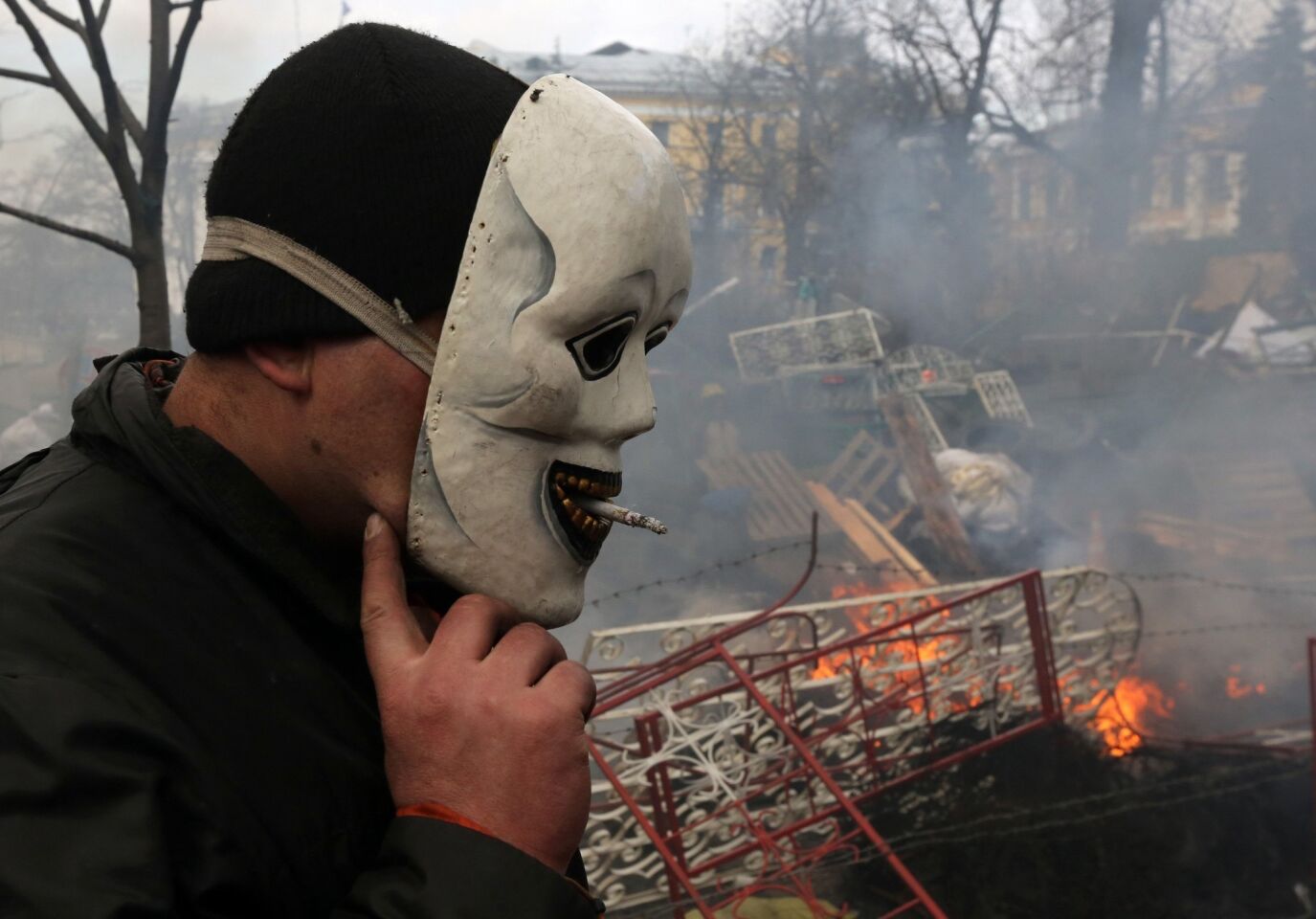 A protester takes a smoke break at the barricades in central Kiev, Ukraine, Thursday, Feb. 20, 2014