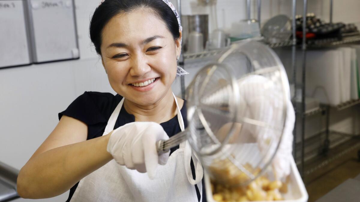Ai Fujimoto mashes soybeans for miso at Crafted Kitchen.