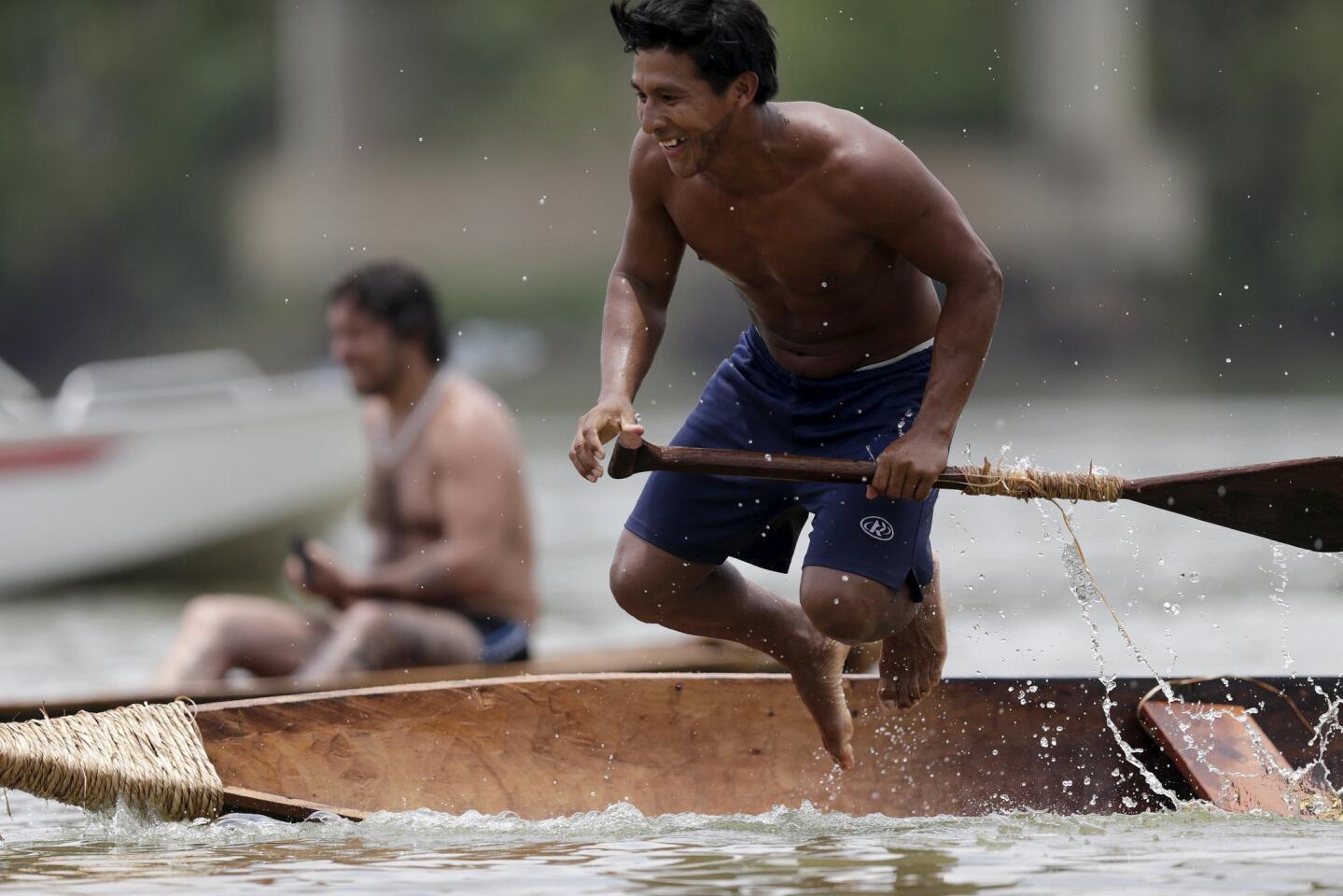 A indigenous man practices canoeing during the first World Games for Indigenous Peoples in Palmas