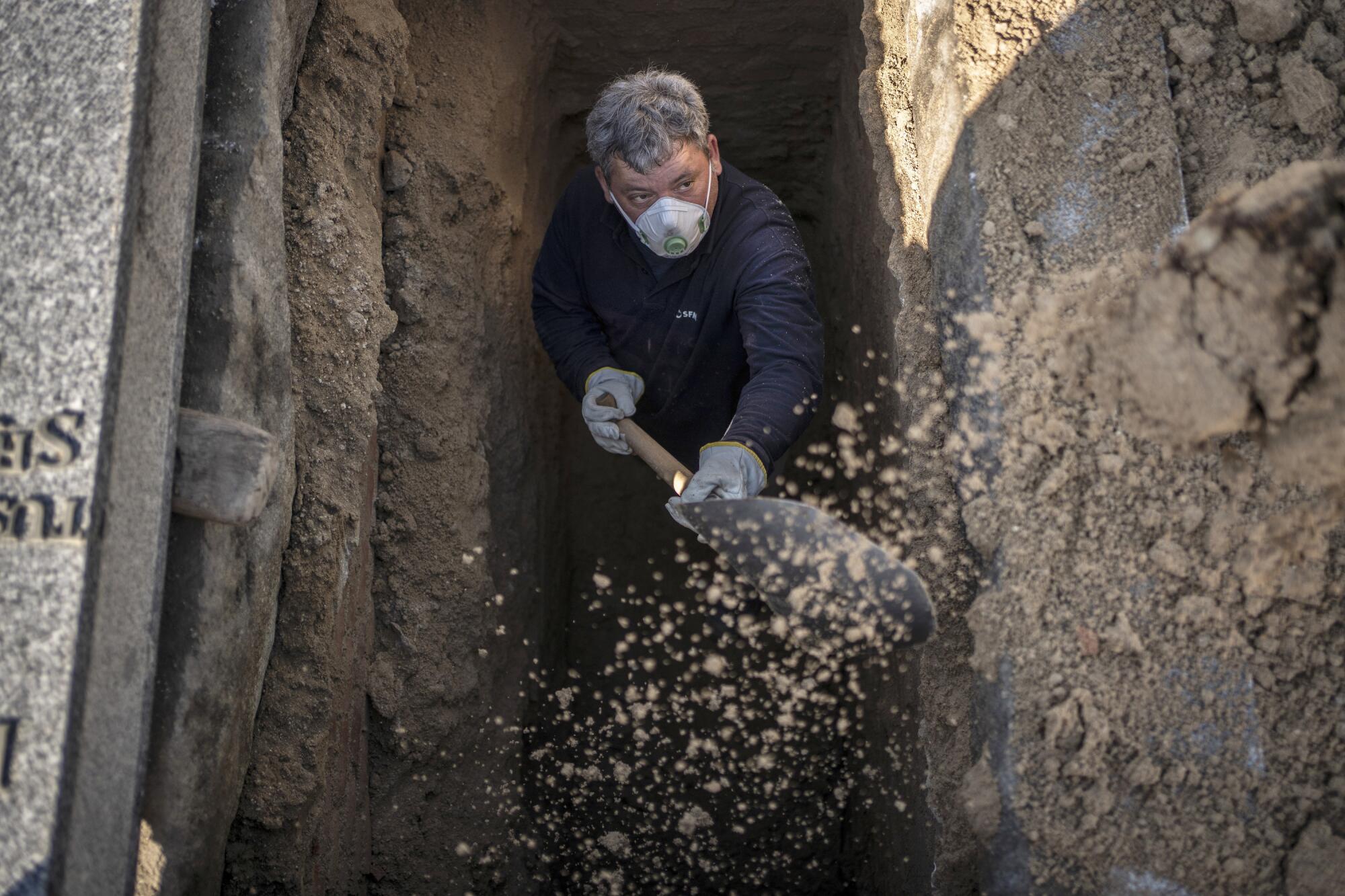 SPAIN:  An undertaker prepares a grave at the Almudena cemetery in Madrid. 